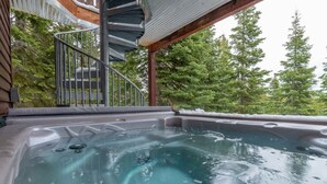 A hot tub in a natural setting with a spiral staircase and surrounding trees. - Tahoe Donner w/ Private Hot Tub (Truckee)