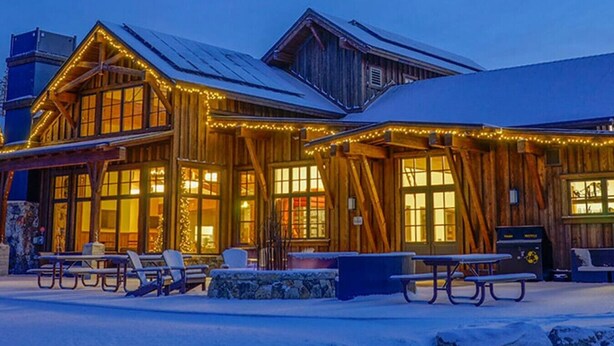 A wooden building with large windows and a covered outdoor seating area. - Tahoe Donner w/ Private Hot Tub (Truckee)
