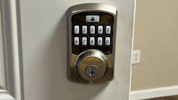 A door with a numeric keypad lock and a keyhole.
