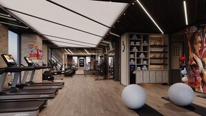 A gym with treadmills, exercise balls, and a variety of fitness equipment.