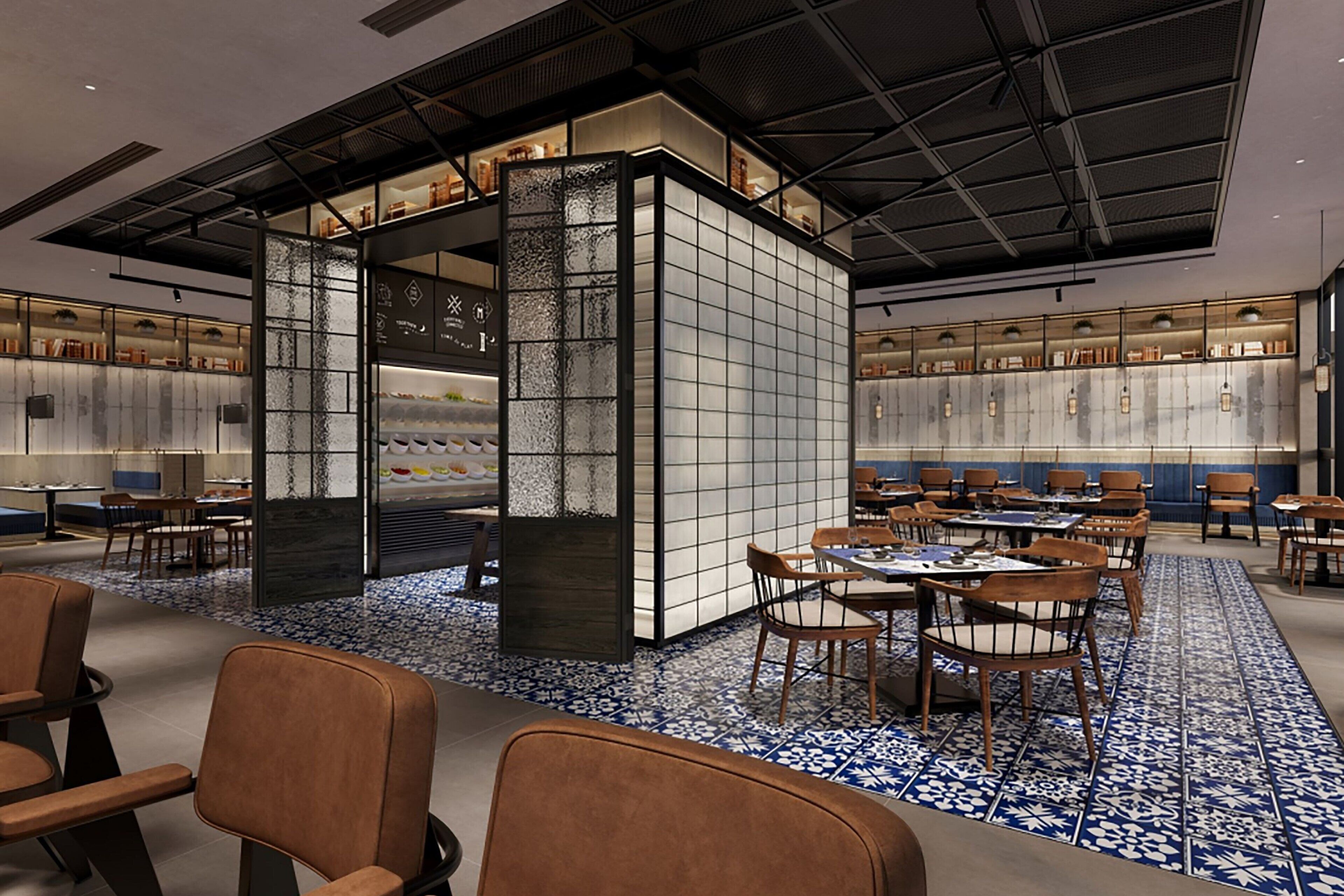 Un restaurante moderno con una zona de estar central, una barra y una cocina visible a través de un panel de vidrio.