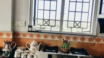 Fridge, stovetop, cookware/dishes/utensils, dining tables