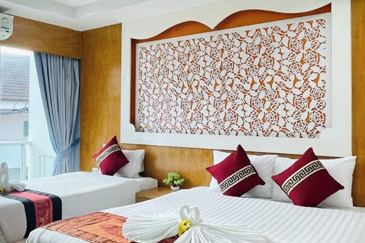 A hotel room with two beds, a decorative wall panel, and a window with curtains.