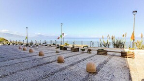 A paved promenade with bollards, benches, and potted plants. - 1 bedroom pet friendly apartment in Trappeto (Trappeto)