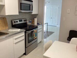 Enjoy cooking in this well-equipped kitchen with a microwave, oven, and ample counter space.