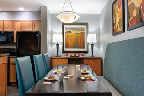 Enjoy meals in this cozy dining area with a long table and comfortable seating for four.