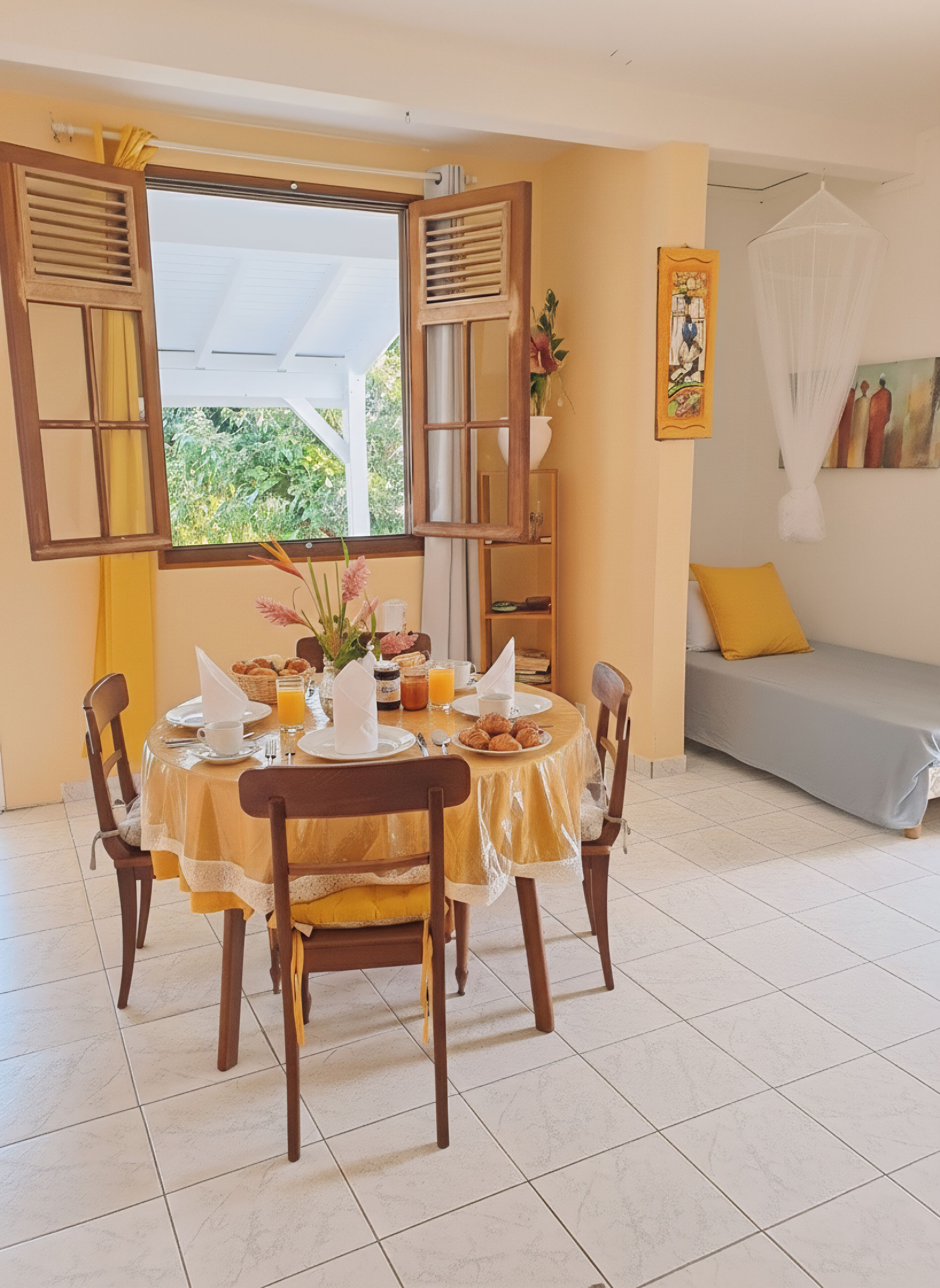 A dining area with a round table, chairs, and a breakfast setting.