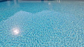 A clear blue pool with a textured surface.