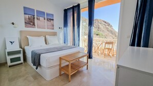 A bedroom with a bed, bedside table, and a view of the outdoors. - Cozy apartment with Jacuzzi/ fast WIFI/PS5/huge pool and kids pool. Family place (CN)