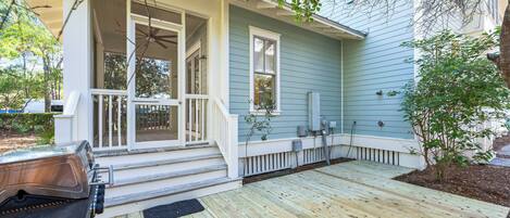 A house with a porch, a grill, and a small garden.