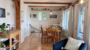 Un coin repas accueillant, avec des meubles en bois, un canapé bleu et une table à manger entourée de chaises.