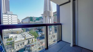 A high-rise building with a view of a cityscape, including a restaurant and a coffee shop.