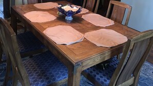 A dining room with a wooden table, six chairs, a chandelier, and a cabinet with glass doors. - Welcome to the Gathering Place! Where Families and friends can gather together.  (McKeesport)