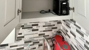A kitchen with a white cabinet containing a blender and a toaster. - COMFORTABLE ORLANDO PRIVATE STUDIO W/FULL KITCHEN! (Orlando)