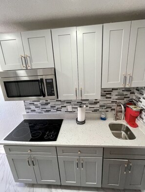 Fridge, microwave, stovetop, coffee/tea maker