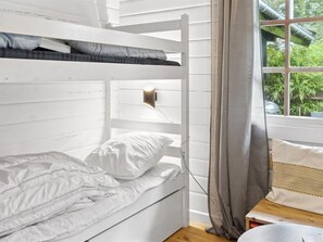 A bunk bed with white bedding and a bedside lamp. - "Neela" - 300m from the sea by Interhome (Væggerløse)