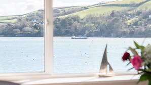 A room with a large window overlooking a lake, a desk, and a chair. - High Tide -  a house that sleeps 6 guests  in 3 bedrooms (Salcombe)