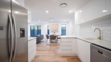 Luxury Townhome | Private kitchen | Full-sized fridge, microwave, oven, stovetop