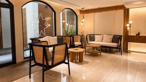 A modern lobby with a sofa, chairs, and a coffee table. - Corridor2407 Hotel (Bangkok)