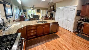 A spacious kitchen with granite countertops, wooden cabinets, and a built-in dishwasher. - 4 Bedroom + 4 Bathroom Mountain Home at 4,700ft Views of Blue Ridge Mts + Big Bald + Spa + Elevator (Mars Hill)
