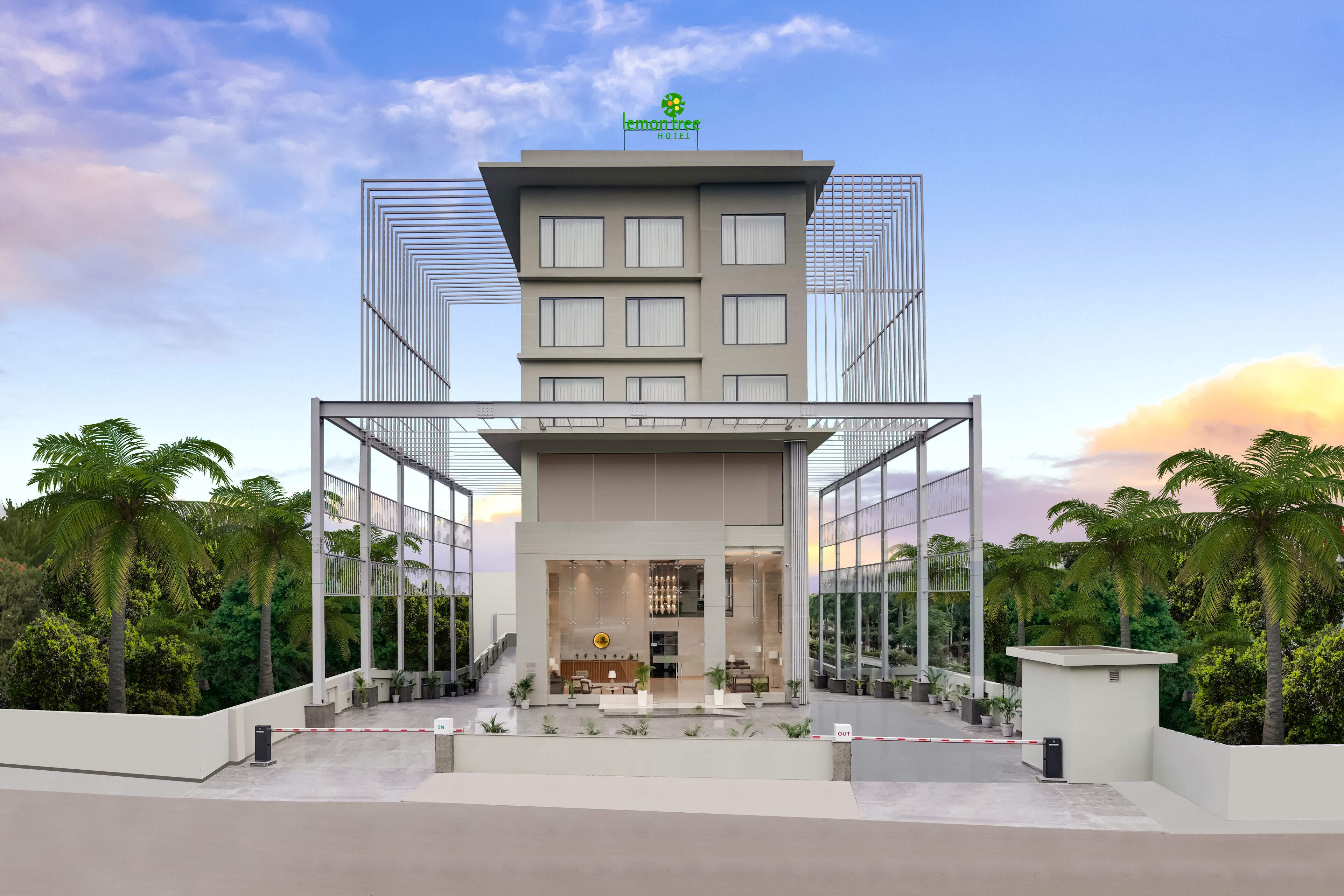 A modern hotel with a central atrium, glass facade, and a rooftop garden.