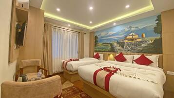 Een hotelkamer met twee bedden, een schilderij van een berglandschap en een kleurencombinatie van rood en wit.