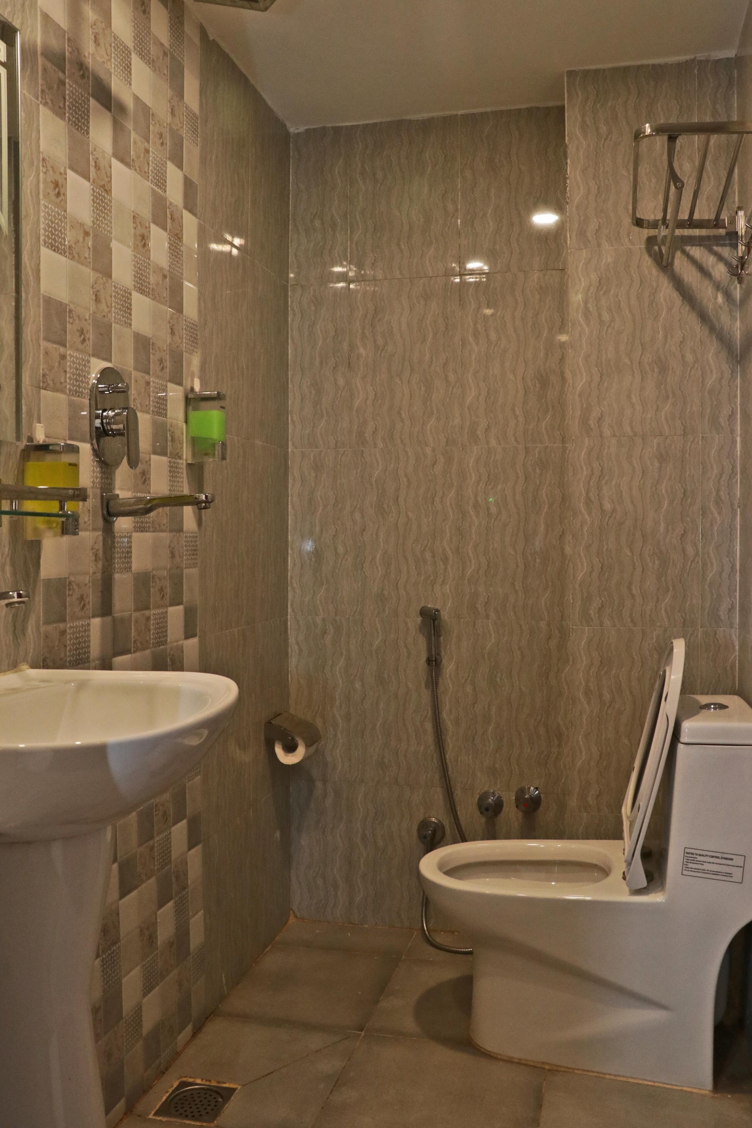 A bathroom with a sink, toilet, and shower.