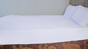 A bed with white sheets and a brown patterned bedspread. - OYO Life 92915 Duta Amnan Syariah (Sidoarjo)