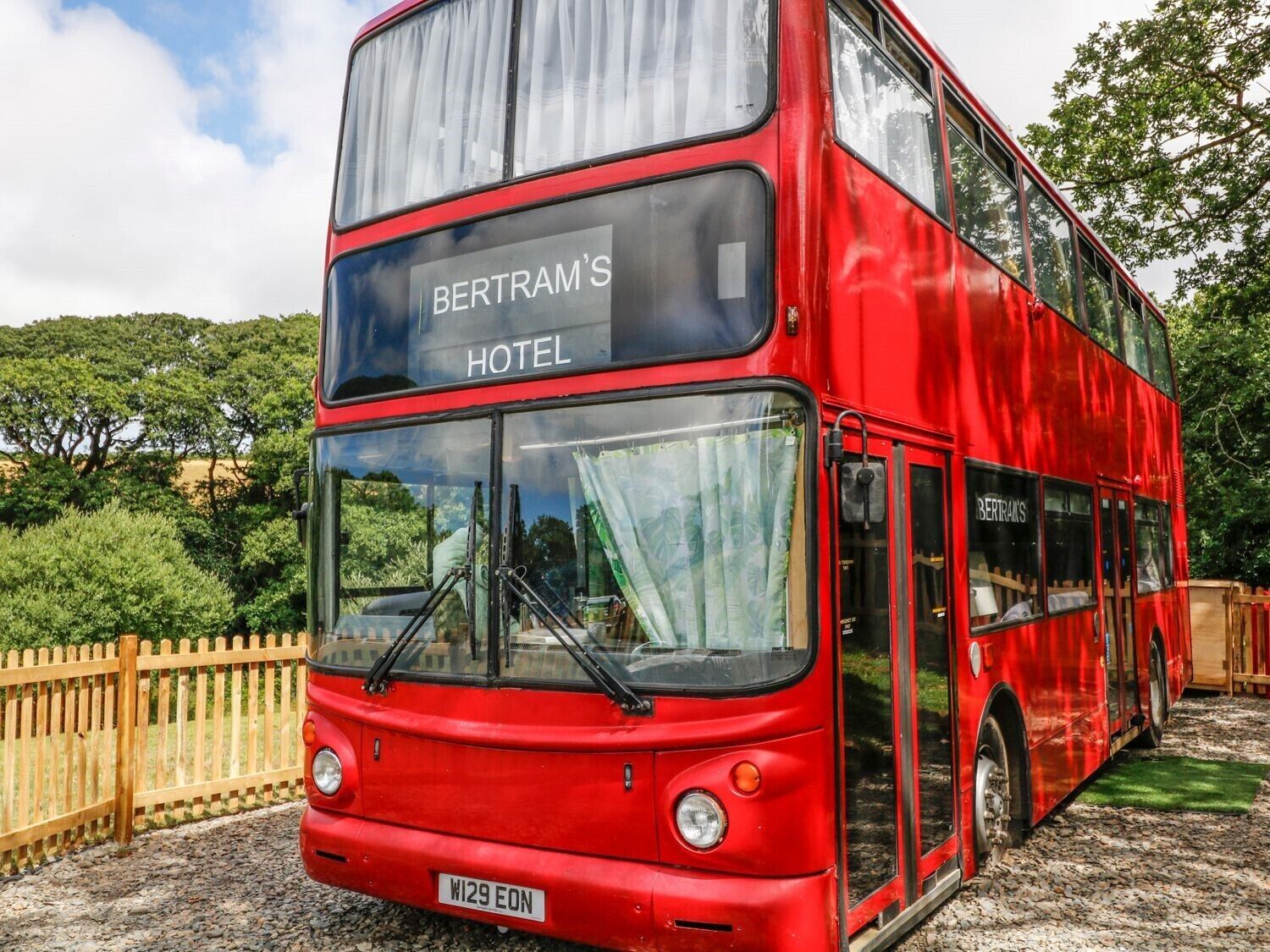 A red double-decker bus with 'BERTRAM'S HOTEL' written on the front.