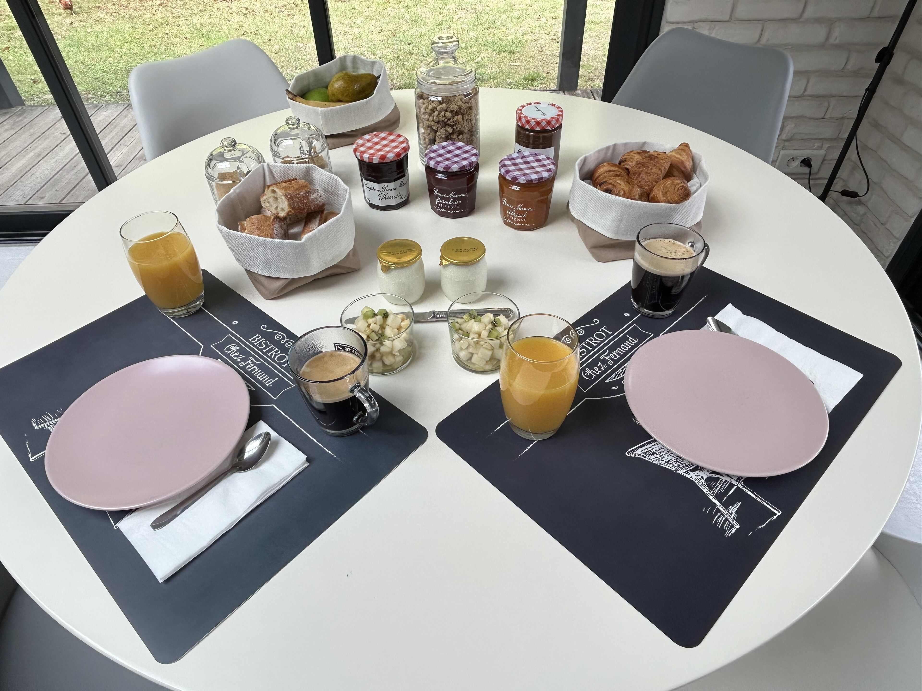 A table set for breakfast with various food items and drinks.