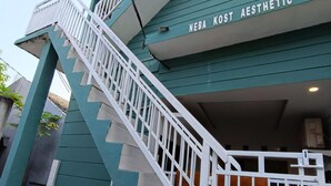 A staircase leading to a building with a sign reading "NEBA KOST AESTHETIC". - OYO Life  92977 Neba Kost Aesthetic (Tangerang)