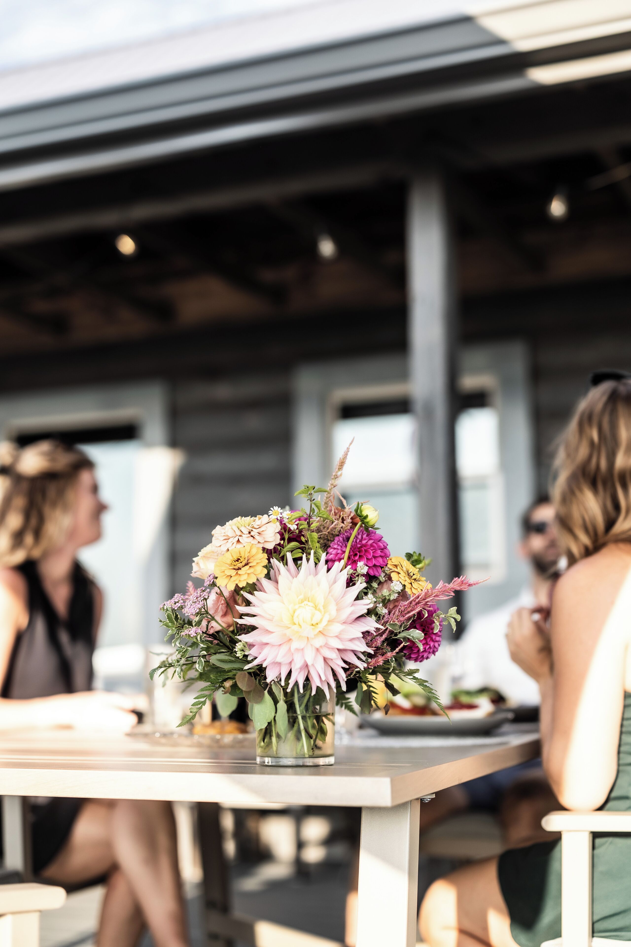 A table with a floral arrangement in a clear glass vase.
