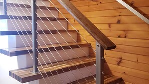 Un escalier en bois avec des rampes en métal et des marches en bois.