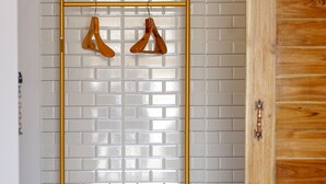 A gold-framed rack with a white mattress and a wooden door in the background. - Chanmuang Resort   (Phetchaburi)