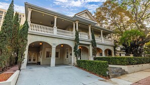 A two-story building with a balcony, columns, and a covered entrance. - Mason Villa in Tampa (Tampa)