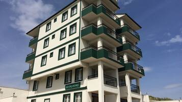 Stylish building with balconies on each floor, offering a unique perspective.