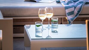 A terrace with a table set for two, overlooking the ocean. - Spectacular Holiday Villa w Private Pool Gym Prima Views (Cape Town)