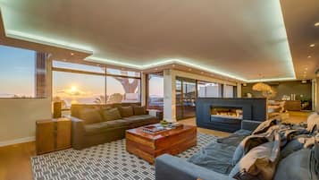 A modern living room with a sofa, coffee table, and fireplace.