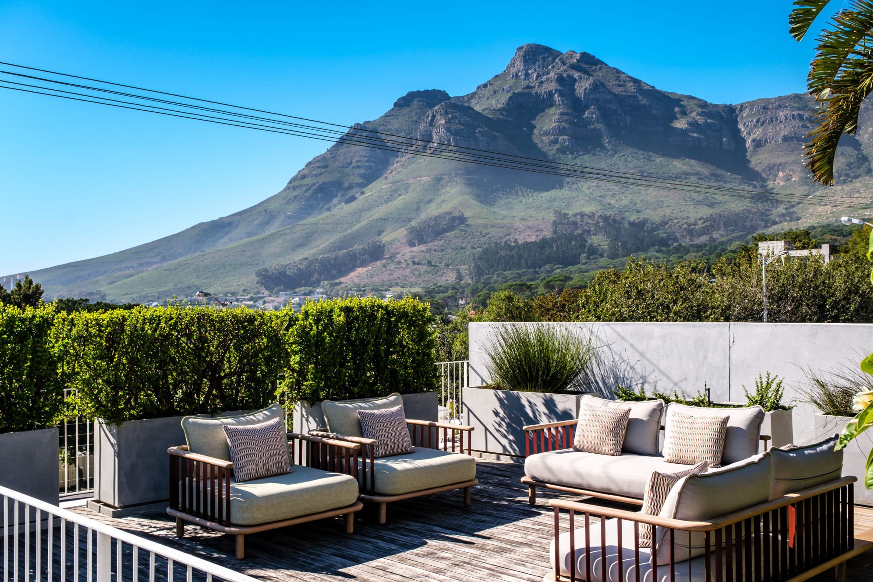 A terrace with outdoor seating and a mountain view.