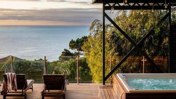 A wooden deck with two lounge chairs and a hot tub overlooking a body of water. - Perfect Family Holiday Villa in Camps Bay Spindrift (Cape Town)