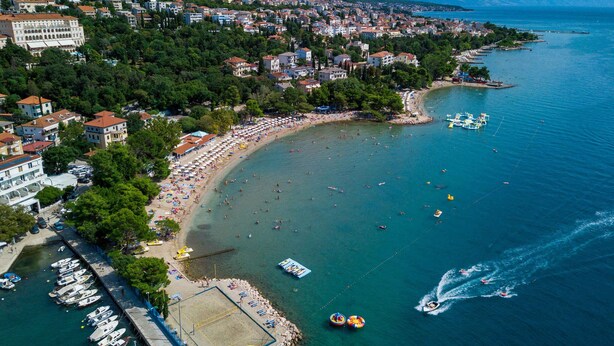 An aerial view of a coastal town with a beach, boats, and a marina. - Holiday apartment with air conditioning (Crikvenica)