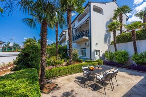 Enjoy outdoor dining or relaxation on the balcony with a patio area featuring a table and chairs.