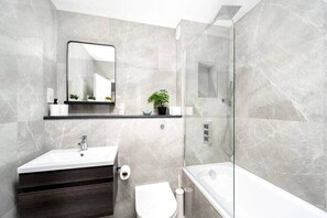 Shower, hair dryer, towels, shampoo