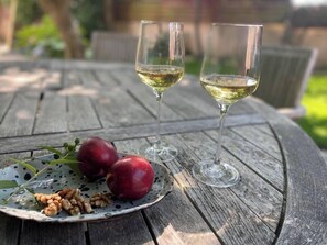 Enjoy a casual outdoor dining experience with a refreshing drink and fresh fruit.