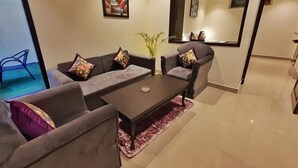 A modern living room with a sofa set, a coffee table, and a potted plant. - The Lake Heritage @Bhimtal Lake (Nainital)
