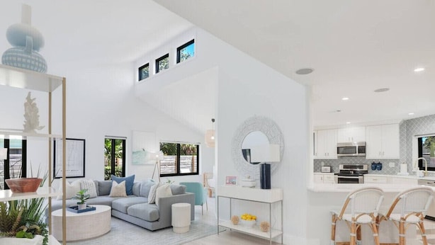 A modern interior with a living area, kitchen, and dining space.