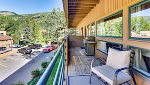 A balcony with a view of a parking lot and surrounding greenery. - East Vail Condo w/ Pool, Hot Tub, & Free Bus Stop (Vail)