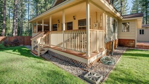 A two-story house with a covered porch, a staircase, and a small deck. - Hike, Boat & Ski: South Lake Tahoe Home (South Lake Tahoe)