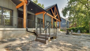 A building with a covered porch, stone steps, and a gravel area. - Riverfront Salesville Cabin Rental w/ Shared Dock! (Mountain Home)