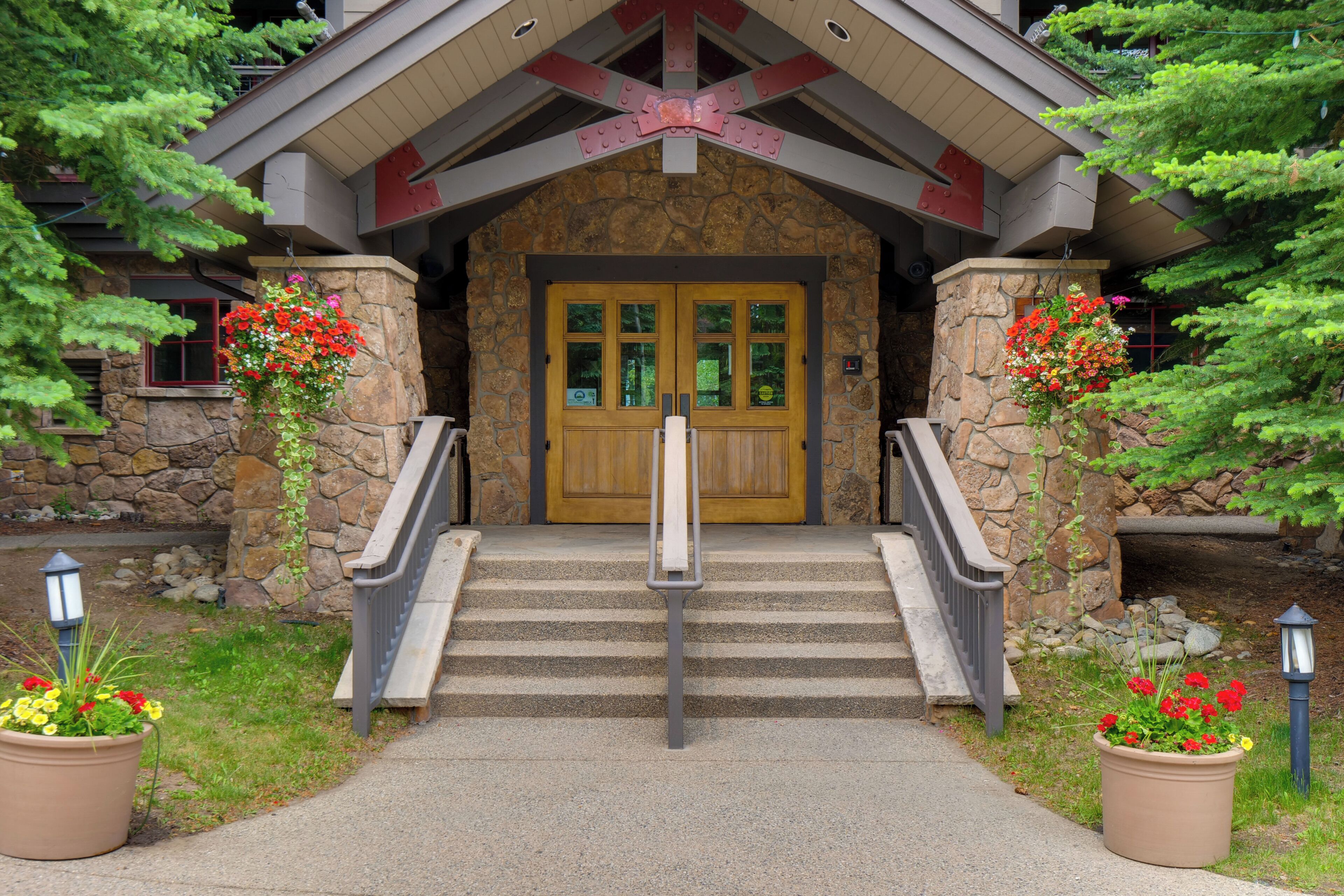 A stone building with a wooden door and a staircase leading up to it.